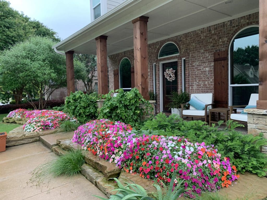 front of home with bright and vibrant floral arrangements